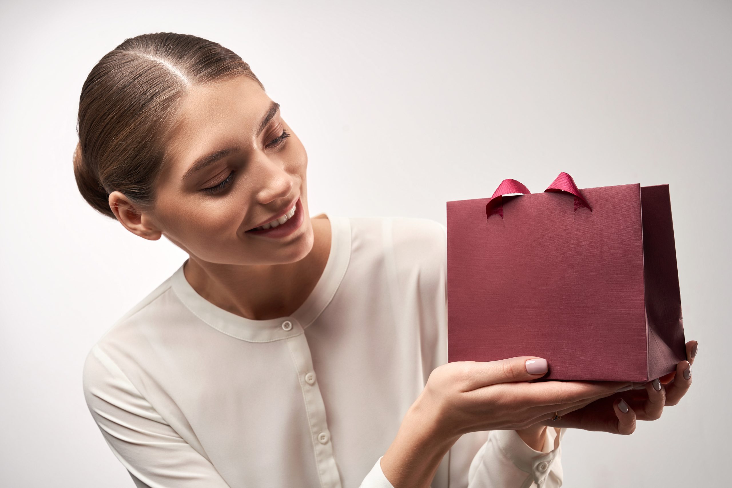 Young model demonstrating gift paper bag.