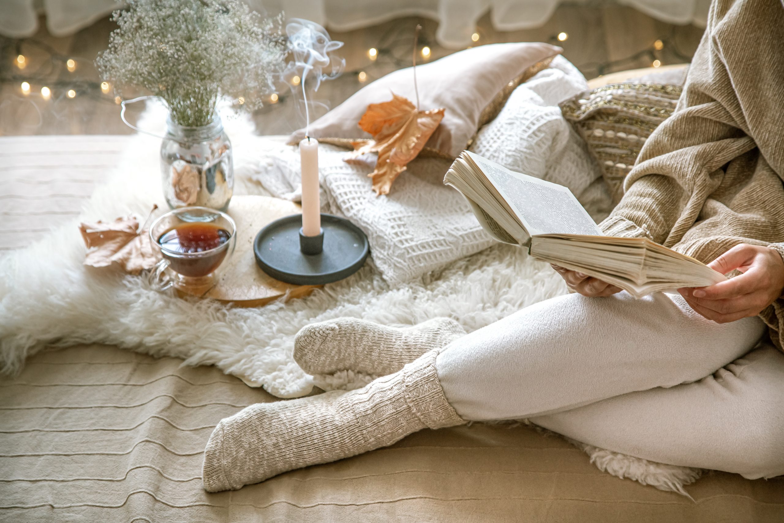 Cozy autumn at home, a woman with a book.