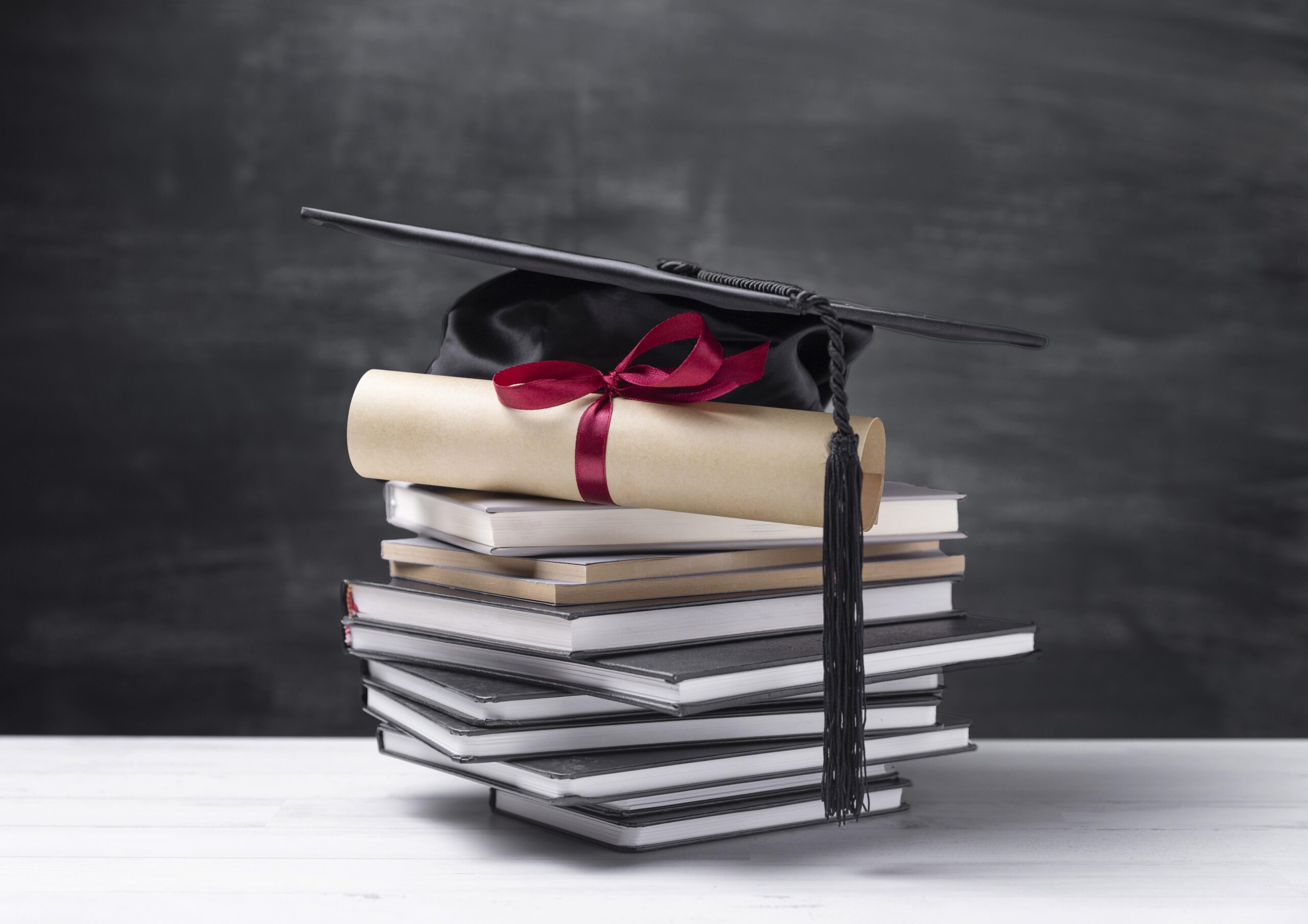 Generic photo of graduation cap and school books