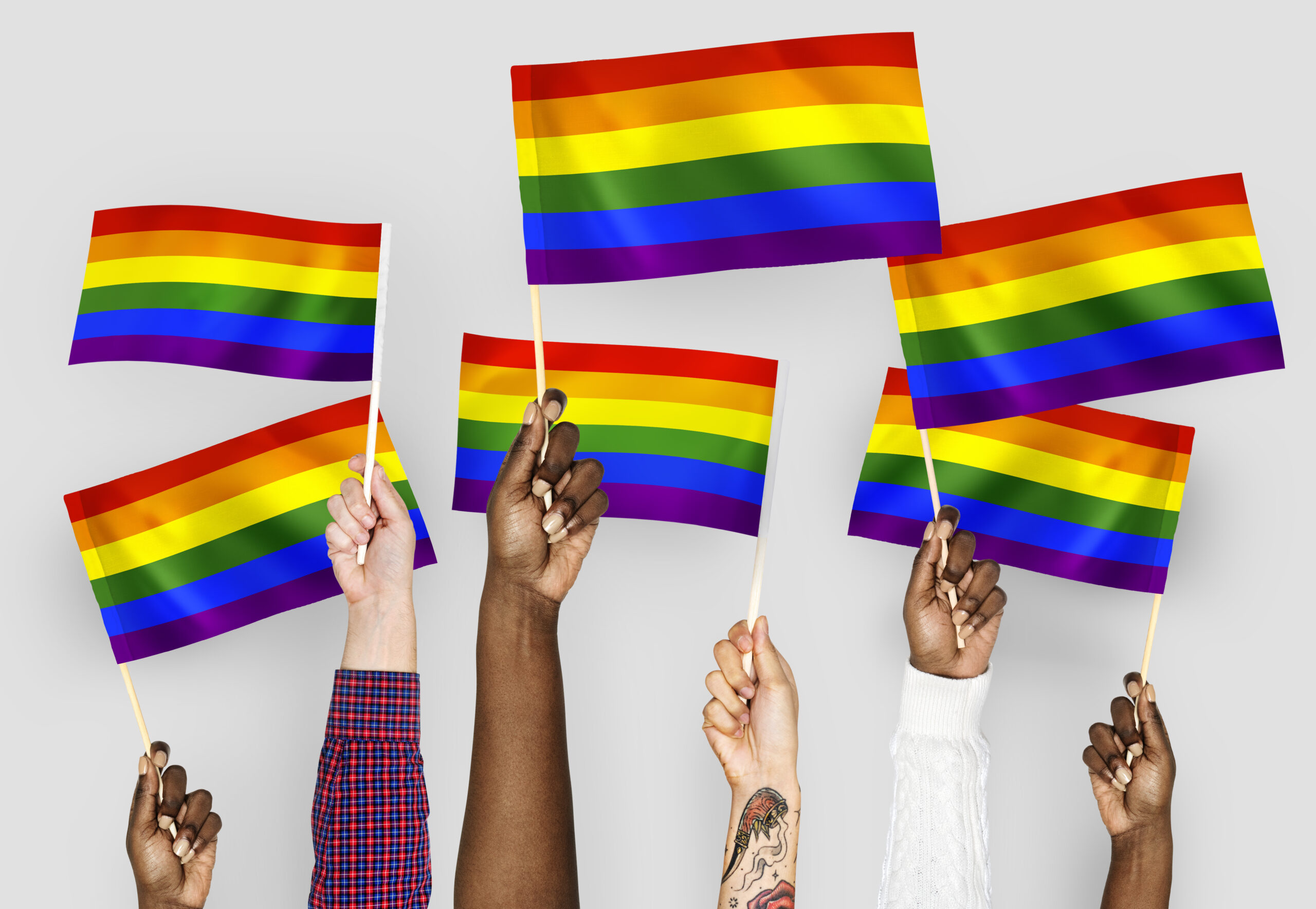 Hands waving pride flags